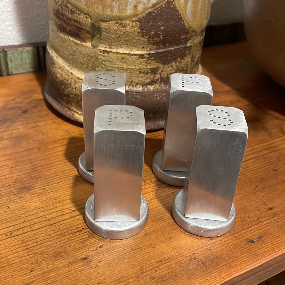 Two sets of hand forged aluminum salt and pepper shakers by Everlast.